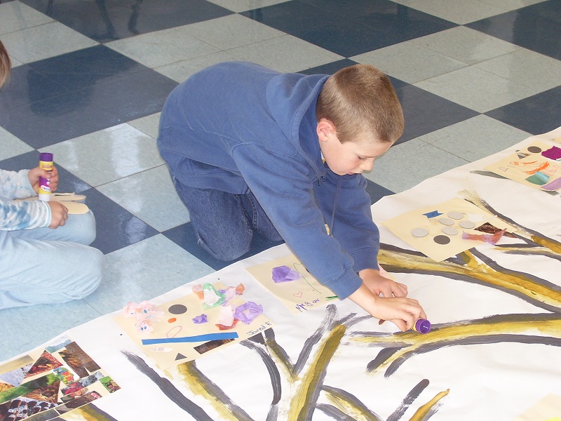 Ryan Tierney, age 8, adds his artwork to a mural at Providence Children's Museum.